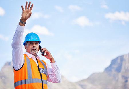 Outdoor, phone call and construction worker talking about building, project management and development in the city. Engineer, architect or senior man on smartphone for industrial work inspectionの写真素材
