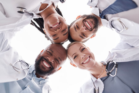 Hospital doctors, circle portrait and happy people for healthcare teamwork, medical support services and clinic help. Medicine solidarity, below view face or group nurses for cardiology collaborationの写真素材