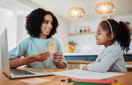 Homework, alphabet card and mother with girl for learning, child development and teaching at home. Family, academic and happy mom with kid at table with letters for lesson, English and knowledgeの写真素材