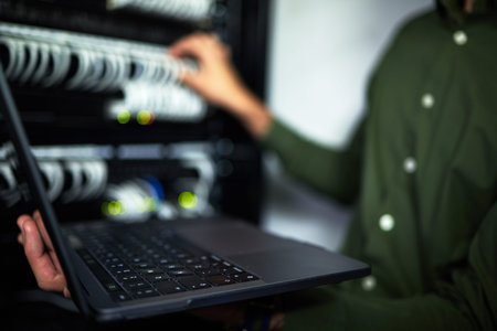 Server room maintenance, laptop and technician at work for cyber security and building network....