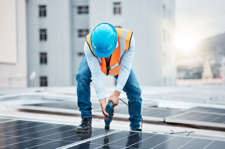 Engineer man, drill and solar panel on roof with industry, sustainability or construction in city....