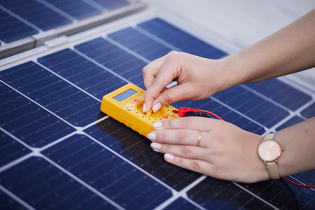 Solar panels, voltage meter and hands for renewable energy, electricity or innovation. Closeup,...