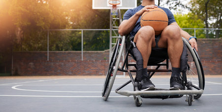 Wheelchair, basketball and man with sports ball at outdoor court for fitness, training and cardio. Exercise, hobby and male with disability at a park for game, workout and weekend fun or active matchの写真素材