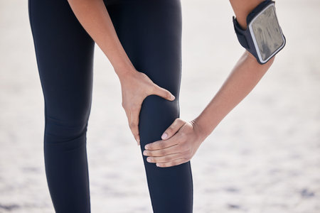 Fitness, knee pain and sports injury with woman on beach for running, inflammation and accident....