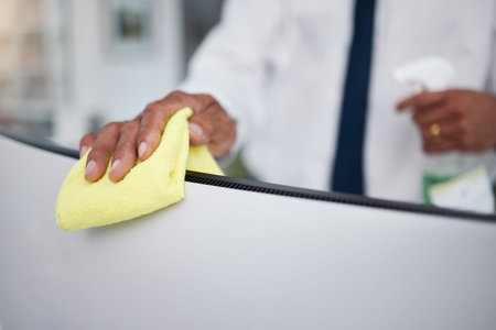 Person, hands and cleaning computer with cloth in office for hygiene, health or safety of virus....