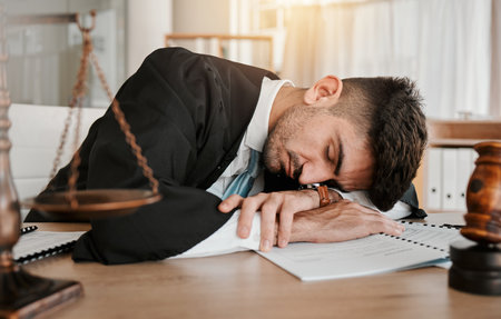 Judge, sleeping and office man tired after working on legal paperwork, court documents or advocate justice. Government, law firm lawyer and male attorney fatigue, dream and burnout after policy workの写真素材