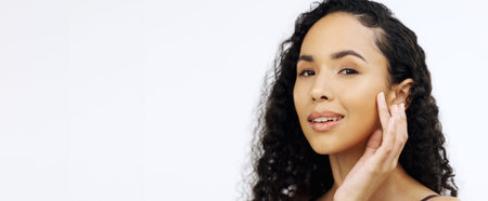 Woman, face or touching face on isolated white background in skincare, collagen success or...
