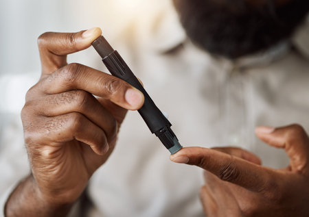 Person, hands and test blood sugar for diabetes, health analysis or medical glucometer results. Closeup of patient poke finger with needle to check insulin, measure glucose risk and diabetic medicineの写真素材