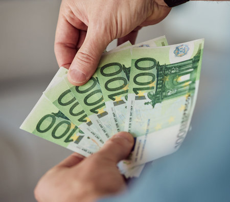 Person, hands and money fan of euros for banking, exchange bills and investment budget of financial...
