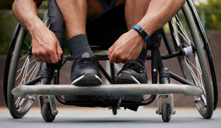 Sports, wheelchair and hands tie shoes ready for training, exercise and workout on outdoor court....