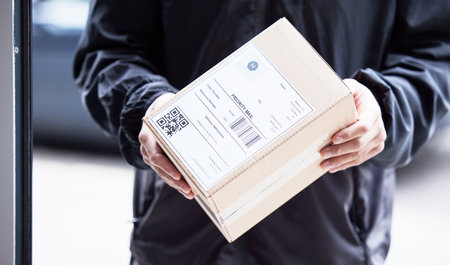 Box, hands and courier at with mail for a delivery, ecommerce work or cargo shipping. Closeup, logistics and man or person with package, stock or front door freight wholesale or distribution serviceの写真素材