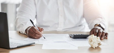 Business person, hands and calculator, planning and writing for finance, taxes management documents or debt review. Accountant paperwork, numbers analysis and budget, investment or bills on computerの写真素材