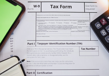 Tax paperwork, closeup and finance with accounting, form for income information, audit and contract. Financial paper, money and taxes with government documents, salary and revenue with calculatorの写真素材