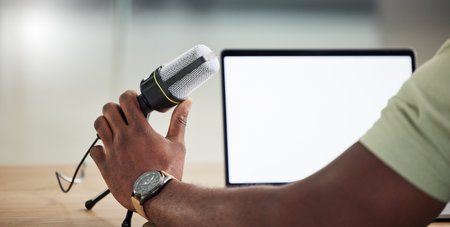 Podcast, tablet and mockup with hand of person for live streaming, radio and speaker. Social media, influencer and communication with closeup of man for microphone, digital and production bannerの写真素材