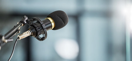 Conference, bokeh and a microphone in an office for a speech, work event or presentation. Mockup, business and a mic or banner for a meeting, workshop speaker or a corporate seminar at the workplaceの写真素材