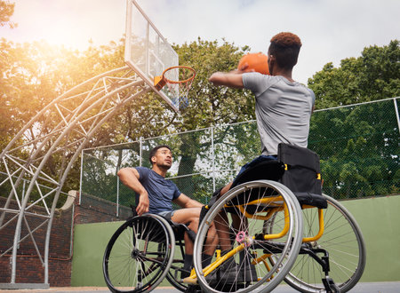 Wheelchair basketball player, shot and sports people play match competition, challenge or practice game skills, target or goal. Outdoor court, shooting workout and athlete with disability, trainingの写真素材