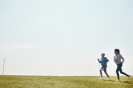 Women are running, fitness and cardio outdoor with training for marathon with mockup space. Female runner team in park, exercise and triathlon race with sports and athlete, health and wellnessの写真素材