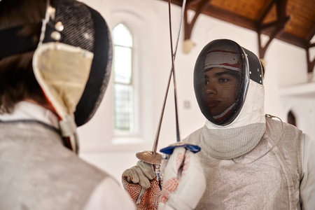 Fencing, start and fight with sword in sports training, exercise or challenge in hall. Martial arts,...