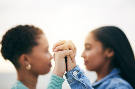 Holding hands, lesbian and queer couple with love, outdoor and romance with support, bonding and...