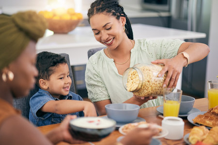 Breakfast cereal, happiness and family eating, giving meal or enjoy quality time together, brunch event and pour morning food. Relax child, mother or parent serving hungry kid in home dining roomの写真素材