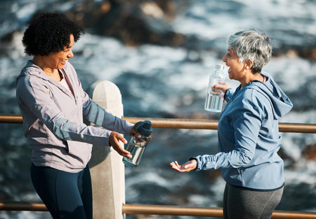 Fitness, health and happy with senior friends at beach for training, running and relax. Comic, support and workout with old women laughing in nature for funny, happiness and wellness togetherの写真素材