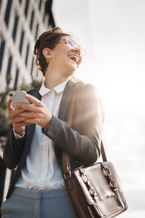 Business, city and woman with a smartphone, funny or travel with internet connection, happiness or email. Female person, humor or consultant with a cellphone, mobile app or outdoor with social mediaの写真素材