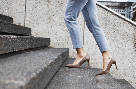 Walking, stairs and shoes of business woman for morning commute, journey and travel in city. Professional, future goals and closeup of female person for career success, work and job progress in townの写真素材