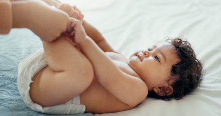 Relax, love and mother with baby on bed for playful, happy and free time. Happiness, care and health with woman and newborn infant in bedroom for family home for support, excited and youthの写真素材