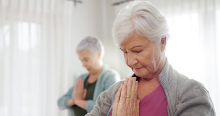 Senior women, yoga and class with friends and retirement home caregiver with a smile. Fitness, elderly group and workout for wellness and health with nurse in a living room with exercise to relaxの写真素材