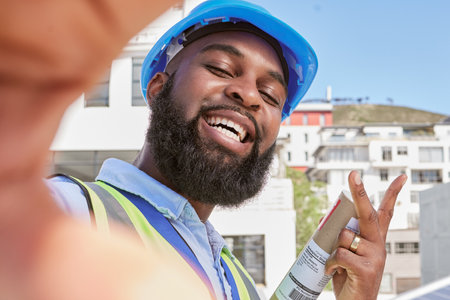 Engineer, selfie and peace with a man outdoor in a city for architecture, building and construction. Face of a happy African male worker or technician for social media, profile picture or memoryの写真素材