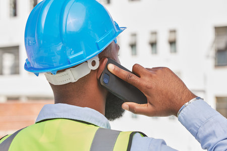 Architecture, phone call and back of black man in city for engineering, communication and contact....