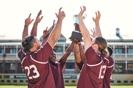 Rugby, team and winner with trophy, champion and men at stadium with success, celebration and achievement. Male people outdoor, exercise and win competition, solidarity and cheers with sports game