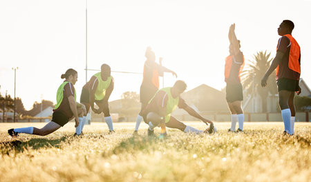Sports, fitness and a rugby team stretching on a field at training in preparation for a game or match together. Exercise, teamwork and warm up with an athlete group getting ready for practiceの写真素材