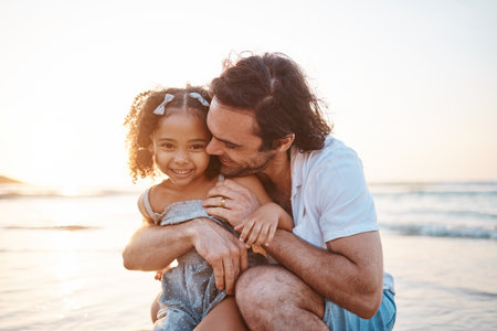 Hug, portrait and a child and father at the beach for holiday, care and love together after adoption. Happy, family and an interracial dad with a girl kid at the ocean for playing, travel or vacationの写真素材