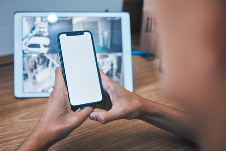 Security guard, back and control room with phone screen, monitor and hands by mockup space for...