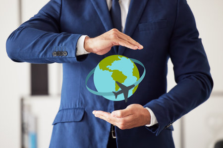 Hands, world and travel insurance with a man in his office to offer protection or cover during a flight. Plane, service or vacation and a business person in a suit with a globe icon for trip safetyの写真素材