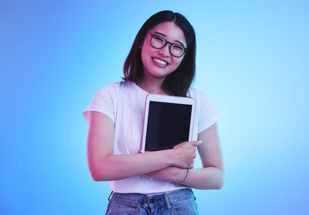 Young woman, student and tablet mockup for online education, e learning or study on blue, studio...