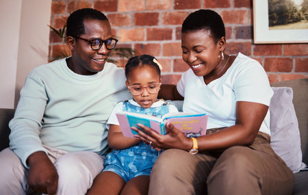 Family, happy and reading a book on a home sofa with glasses for learning, knowledge and time...