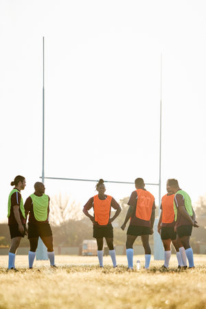Rugby, training and men on field for motivation at game, match or practice workout together. Sports, fitness and team at poles on grass with energy, talent and inspiration for winning at challenge.の写真素材