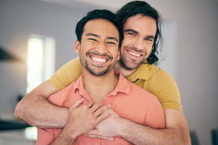 Smile, portrait and gay couple hug, happy and love in their home with freedom on the weekend together. LGBT, face and man embrace boyfriend in a living room with care, romance and relationship prideの写真素材