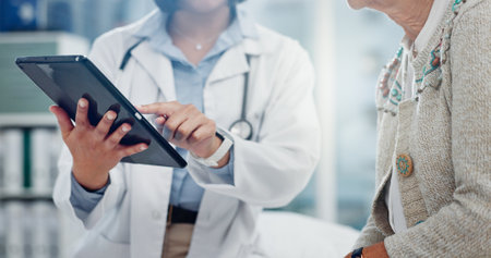 Tablet, doctor hands and people for healthcare information, test results and support or helping. Typing, search and medical professional with patient charts on digital technology for clinic servicesの写真素材