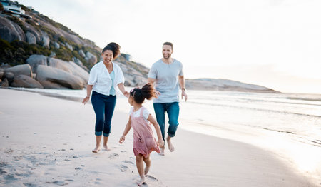 Family, running and happiness on beach, travel with mother, father and kid outdoor, fun together with games and bonding. Travel, adventure and playful, parents and child with happy people and energyの写真素材