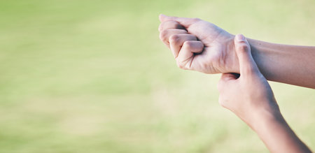 Wrist pain, sports person and hands injury from grass pitch challenge, lawn field workout or exercise problem or mistake. Medical emergency mockup, joint sprain or closeup athlete with muscle anatomyの写真素材