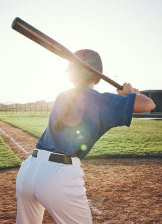 Baseball, bat and a person outdoor on a pitch for sports, performance and competition. Behind professional athlete or softball player for game training at a field or stadium in summer with lens flareの写真素材