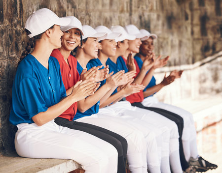 Sports, baseball dugout and team applause for motivation, match winner and game praise, contest or competition support. Player achievement, success and women clapping, congratulations and teamworkの写真素材