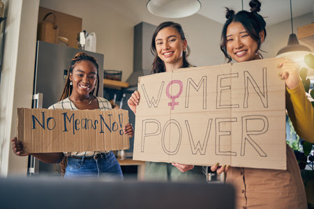 Women, poster and preparation in home for protest, portrait or support for diversity, empowerment or goals. Girl friends, cardboard sign or ready with billboard for justice, human rights or equalityの写真素材