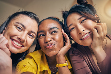 Selfie, friends and women happy, relax and bond in a living room at home together on the weekend. Portrait, smile and people with diversity pose for profile picture, blog or social media memory postの写真素材
