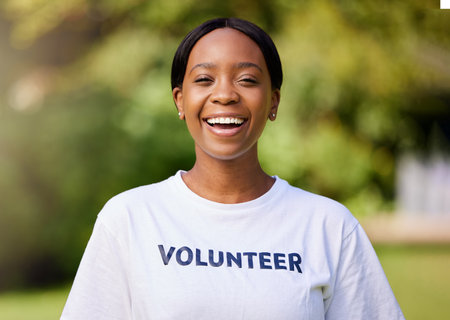 Happy, park volunteer and portrait of a black woman for cleaning, community work and service. Smile, young and an African girl or charity worker in nature for waste management or social projectの写真素材