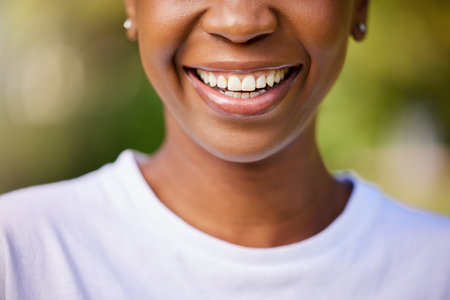 Smile, closeup and mouth of a woman for dental health, oral hygiene and dentist results in nature. Beauty, wellness and lips or teeth of a person for whitening progress, healthcare or cleaningの写真素材
