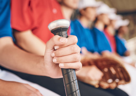 Hand, softball and bat with sports and team, fitness and mission with closeup, people in dugout...